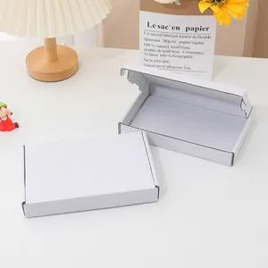 High quality minimalist white corrugated mailer box detail showing open and closed views