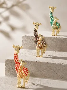Elegant giraffe enamel brooches in red brown teal on stone steps texture backdrop