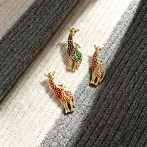 Detailed macro shot of various colorful enamel giraffe mother and child brooches on knitwear