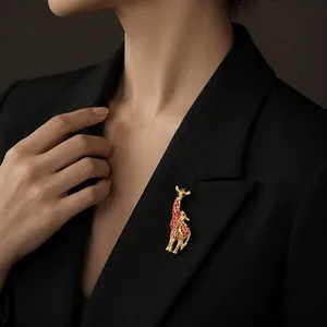 Elegant gold and red enamel giraffe brooch pinned on a black blazer