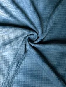 Macro detail of blue waffle knit fabric texture for men's long sleeve T-shirt