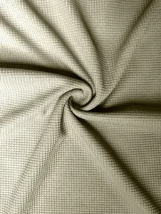 Close-up macro view showing the textured weave of premium olive waffle knit fabric