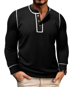 Close-up of men's black waffle knit long sleeve henley shirt with white piping detail