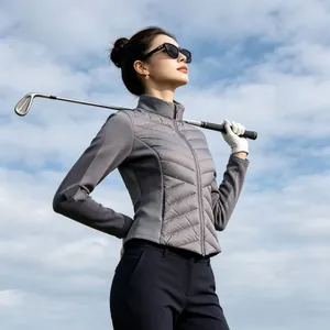 Outdoor view of a slim gray lightweight down jacket for women on a golf course