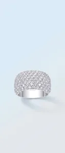 Close-up of sparkling full-pavé moissanite gems on a wide sterling silver ring