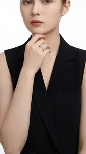 Close-up of a model wearing a luxurious wide S925 silver ring with pavé moissanite stones.