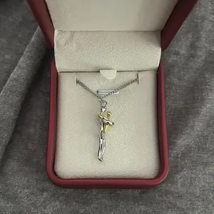 Creative abstract hugging couple pendant necklace presented in a red jewelry gift box