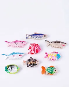 Vibrant collection of ocean animal hair claw clips featuring sharks and tropical fish motifs