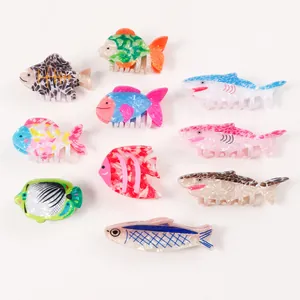 Collection of colorful sea animal hair claws featuring sharks and tropical fish designs