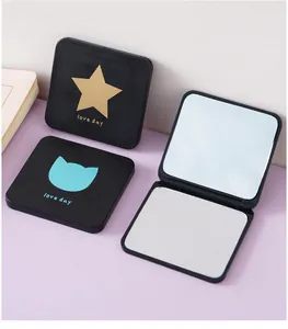 Close-up detail of a portable square makeup mirror with a foldable double-sided design