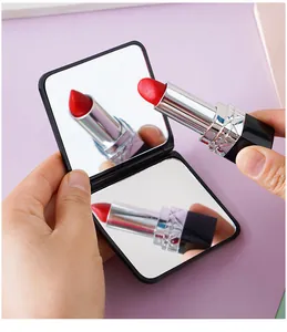 Close-up of a foldable double-sided square makeup mirror with clear reflection