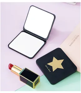 Close-up detail of a portable folding square makeup mirror with elegant gold star design