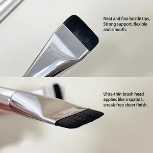 Detailed close-up showing the dense bristles and thin head of a flat foundation brush