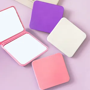 Detailed view of colorful portable square folding makeup mirrors showing double-sided design.