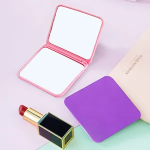 Detail of a compact folding mirror with a double-sided design for on-the-go makeup