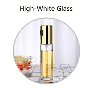 Detailed view of an elegant glass oil spray bottle with a golden lid for kitchen and BBQ use