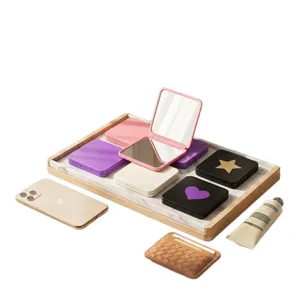 Portable double-sided square folding makeup mirror in multiple colors on marble tray