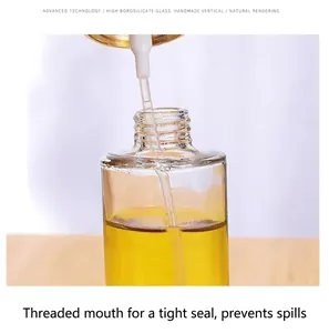 Close-up of leak-proof threaded neck on a clear glass oil spray bottle for kitchen use.