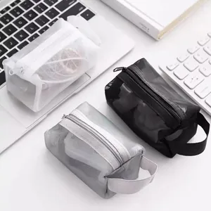 Portable nylon mesh storage bags for cosmetics and electronic cables on white desk