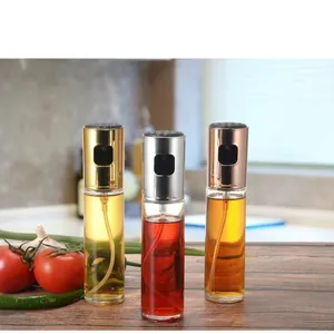 Set of three glass oil sprayer bottles with metallic lids for kitchen cooking and BBQ
