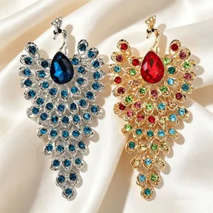 Vue détaillée de broches de paon en strass colorés dans les tons argent et or exquis