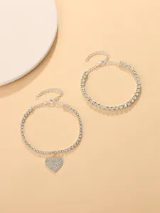 Macro view of sparkling rhinestone anklet set featuring a detailed heart-shaped charm