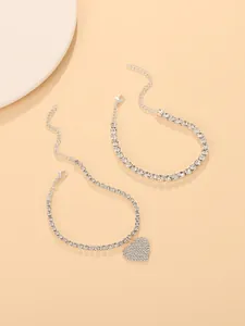 Detailed view of silver-toned 2-piece rhinestone anklet set with a sparkling heart charm.