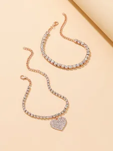 Close-up of elegant two-piece rose gold rhinestone anklet set with heart charm