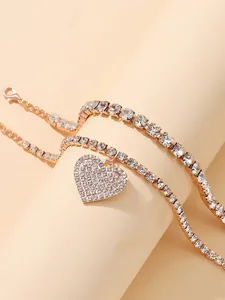 Detailed view of two-piece rose gold anklet set with sparkly heart rhinestone pendant