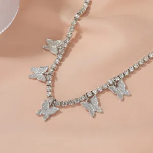 Close-up of sparkling rhinestone butterfly anklet on elegant pink satin background