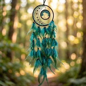 Close-up of handmade turquoise dreamcatcher featuring a tree of life and soft feathers