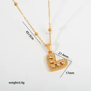Macro view of a gold heart pendant with crystal inlay showing precise measurements