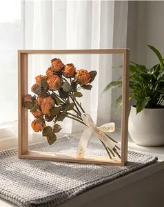 Detailed view of vintage orange artificial roses tied with an Eternal ribbon in a frame