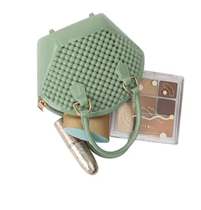 Mini green jelly shell bag with beaded texture and cosmetics