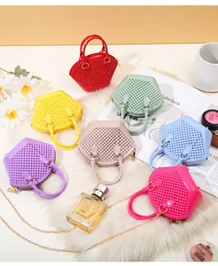 Seven vibrant mini beaded jelly shell bags with gold chain straps on a soft white fur rug.