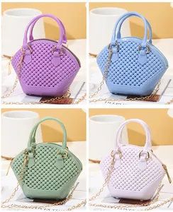 Four colors of mini shell-shaped jelly bags featuring bead texture and gold chain straps