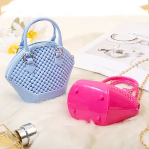Stylish mini beaded jelly shell bag with a gold chain strap shown on a fluffy rug