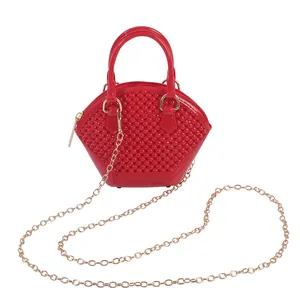Stylish red mini jelly shell bag featuring beaded texture and gold chain strap for women