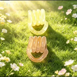 Set of two temperature color changing Tangle fidget sensory toys displayed on green grass