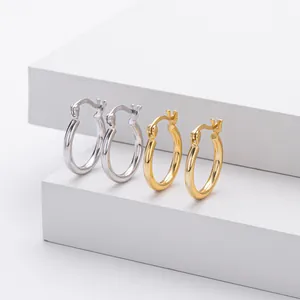 Detailed view of silver and gold-toned S925 sterling silver hollow hoop earrings on a white stand