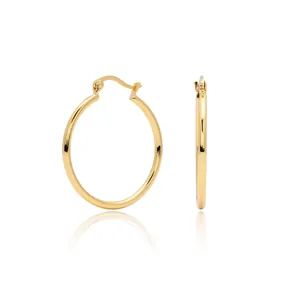 Detailed view of polished gold hoop earrings featuring a secure clasp and sleek round tube design