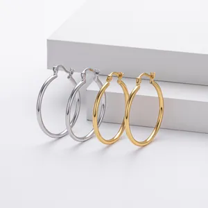 High-polished S925 sterling silver and gold-plated hoop earrings on minimalist display