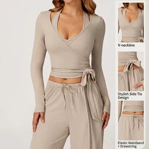 Detailed view of beige V-neck wrap yoga top and elastic drawstring pants set.