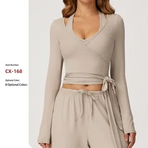 Elegant long sleeve wrap-style beige yoga top paired with matching drawstring pants