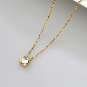 Macro view of gold stainless steel necklace featuring a single round zircon pendant