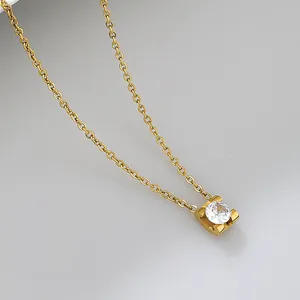 Detailed close-up of a minimalist gold stainless steel necklace with a round bezel-set zircon