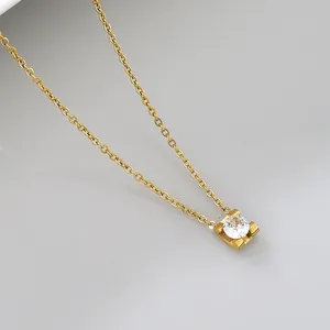 Close-up of gold-plated stainless steel necklace with single clear zircon pendant