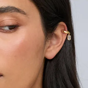 Detail view of a gold-plated stainless steel ear cuff with a square zircon charm