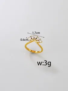 Detail view of gold chevron ring in stainless steel with pear-cut cubic zirconia