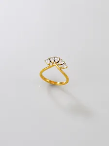 Close-up of a gold stainless steel V-shaped ring featuring five teardrop cubic zirconias